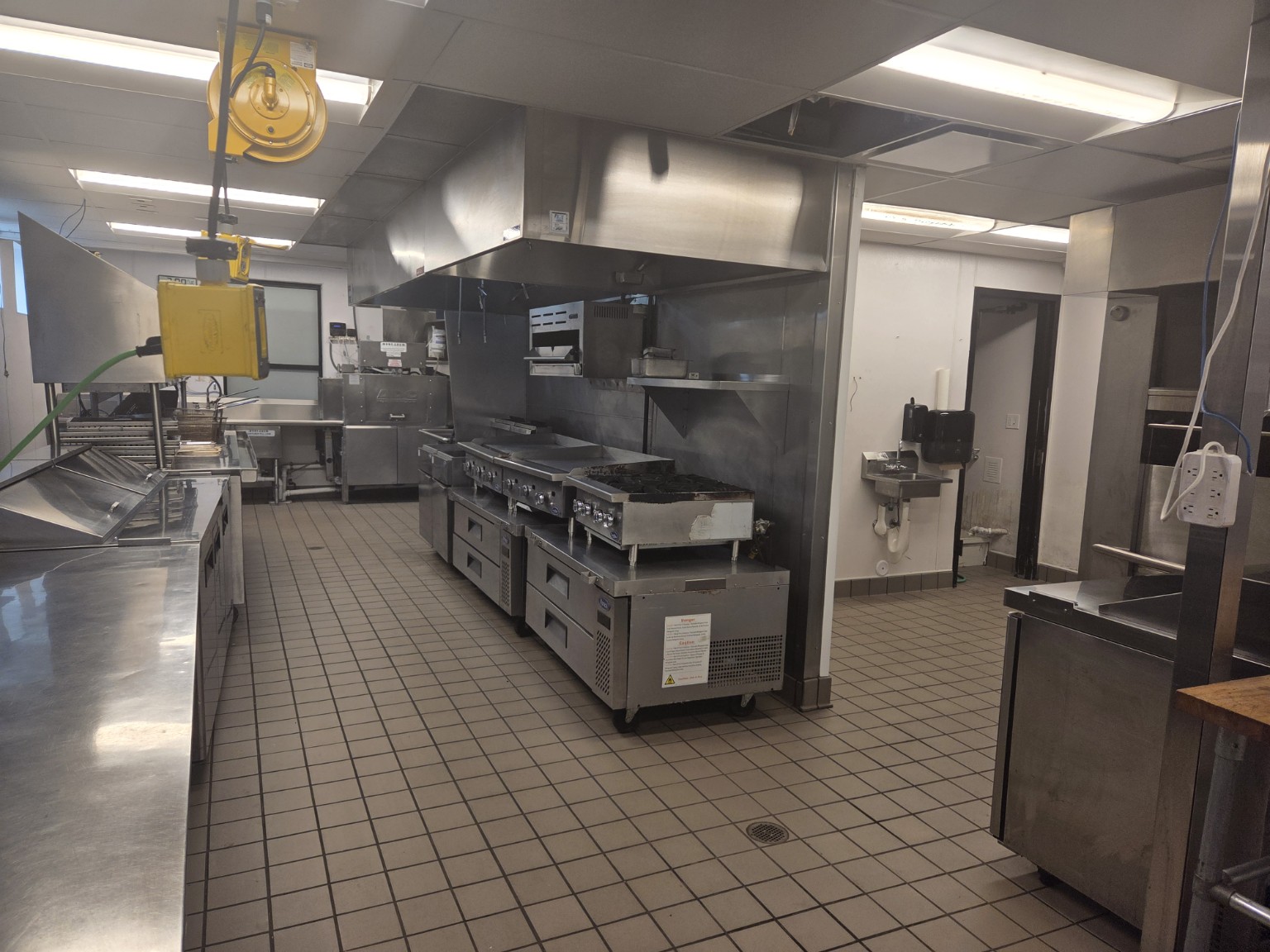 Commercial stainless steel kitchen equipment and tiled floor