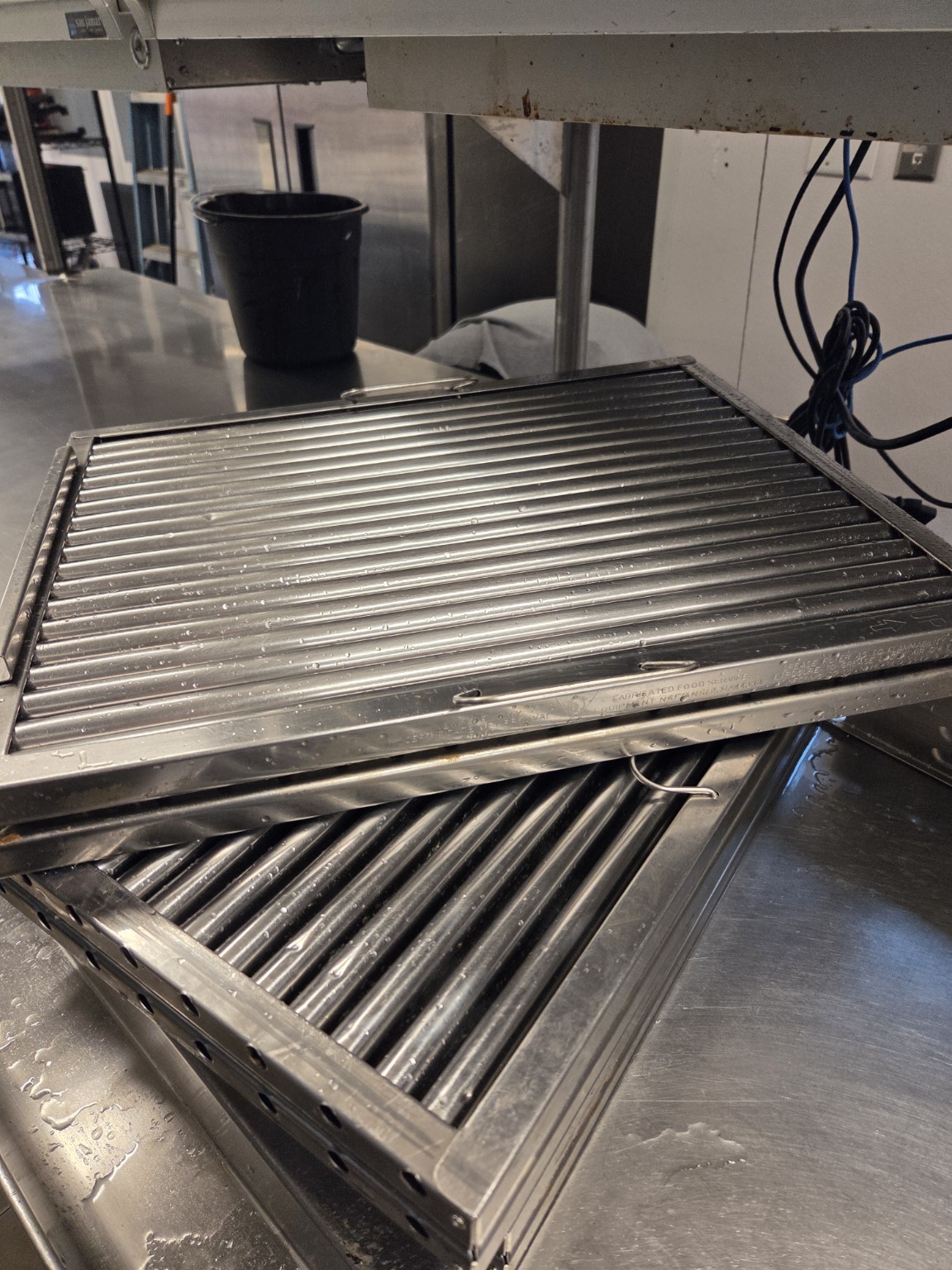 Close-up stainless-steel commercial baffle filters after cleaning
