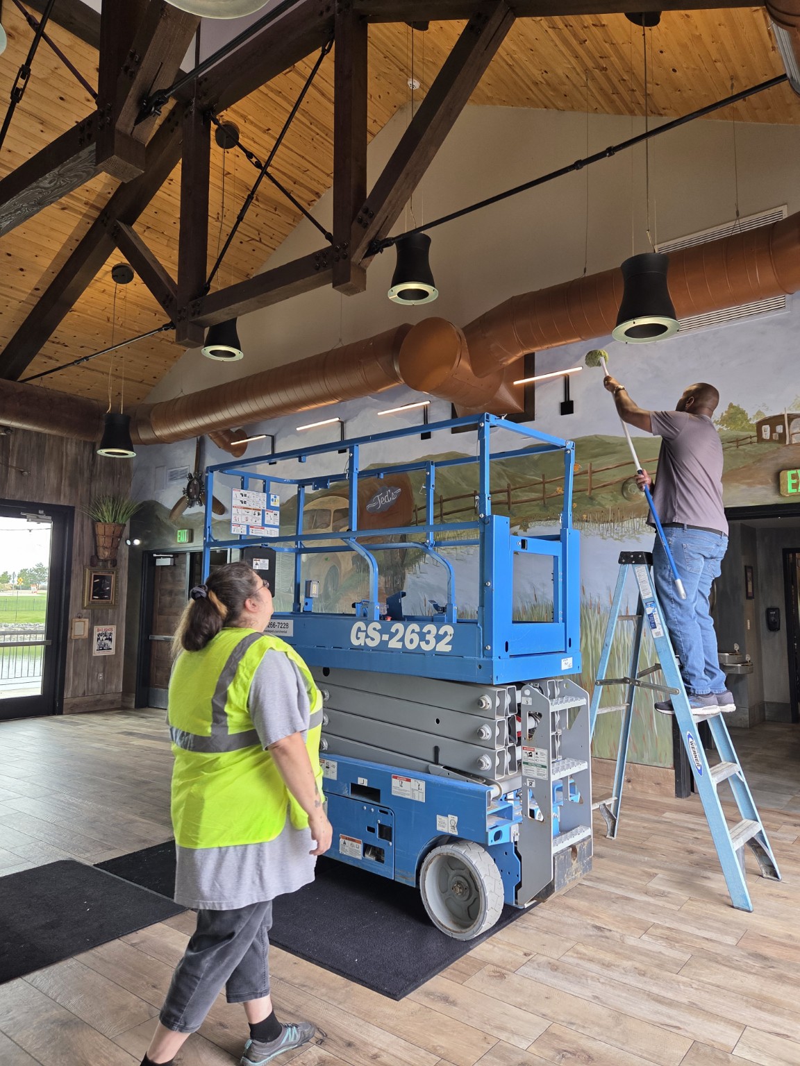 Northern Lights Cleaning team member working at elevation on a commercial project